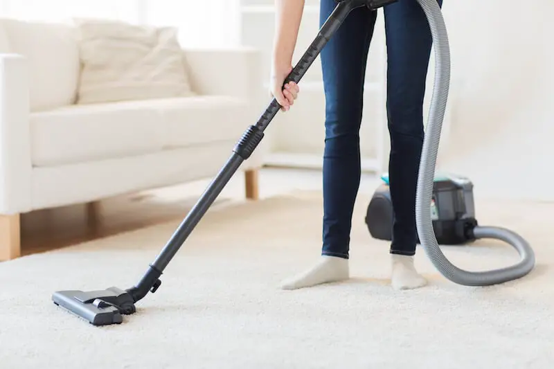 Cleaning carpet with a canister vacuum